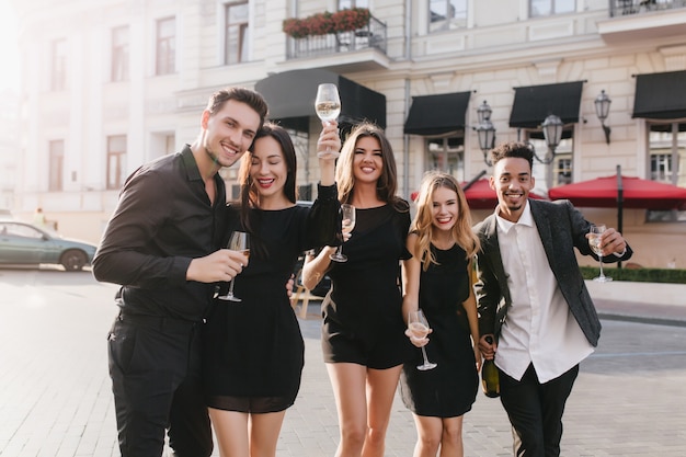 Joyeux amis buvant du champagne à la fête en plein air