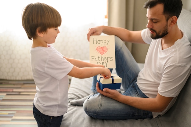 Photo gratuite kid donnant un cadeau à son père