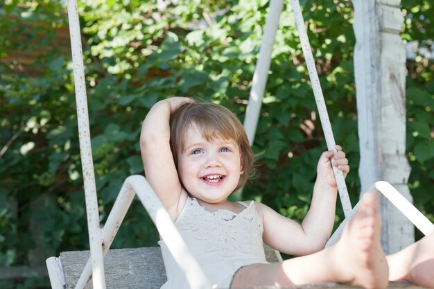 Laughing girl on swing