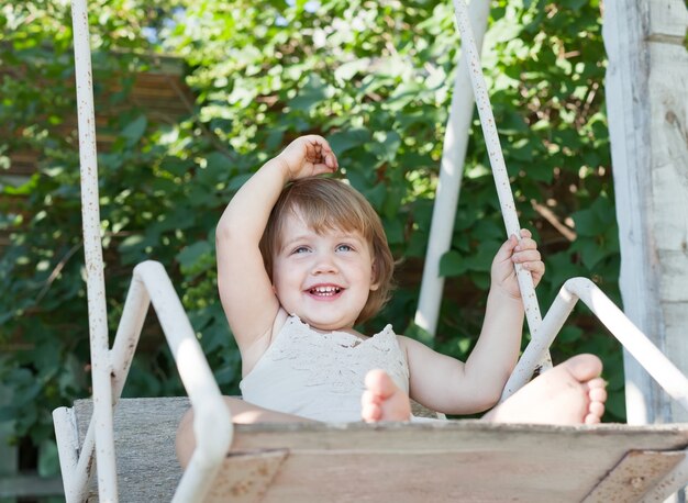 Laughing girl on swing