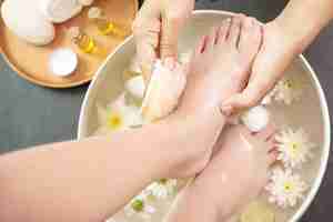 Photo gratuite lavage des pieds au spa avant le traitement. traitement spa et produit pour pieds féminins et spa pour les mains.