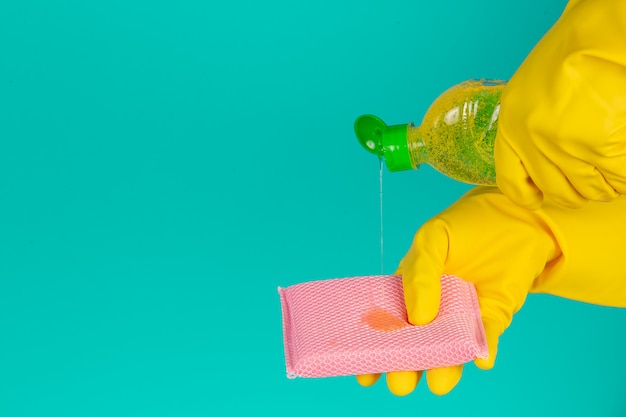 lave-vaisselle portant des gants jaunes sur un bleu.