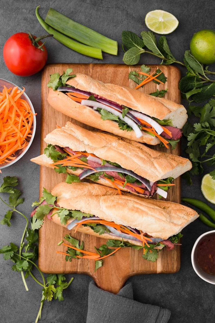 Photo gratuit lay plat de sandwiches frais sur une planche à découper