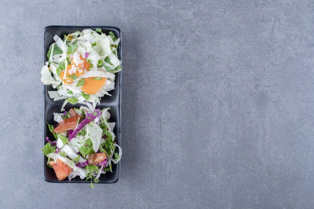 Légumes râpés dans le bol, sur la surface en marbre.