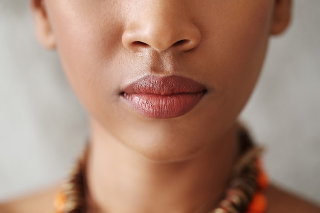 Lèvres féminines avec rouge à lèvres rouge naturel, peau noire