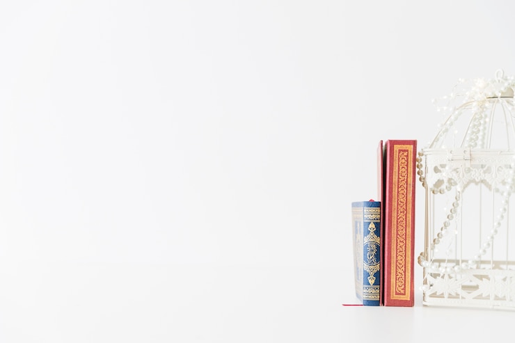 Photo gratuit des livres religieux debout avec une cage d'oiseaux