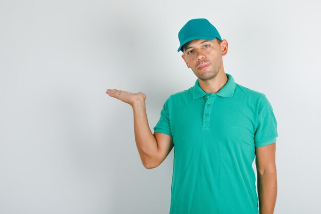 Livreur tenant la main ouverte en t-shirt vert et casquette