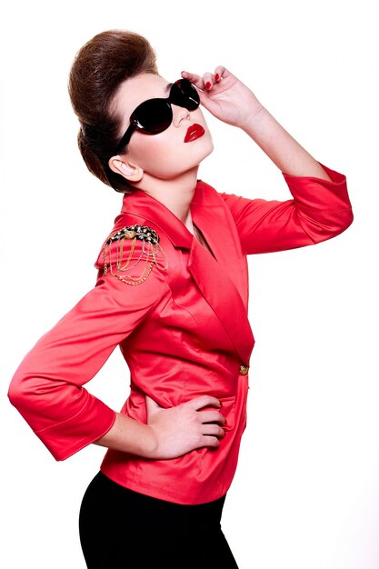 Look haute couture. Glamour close-up portrait of sexy brunette caucasian young female woman with bright make-up with red lips in bright pink jacket in sun glasses