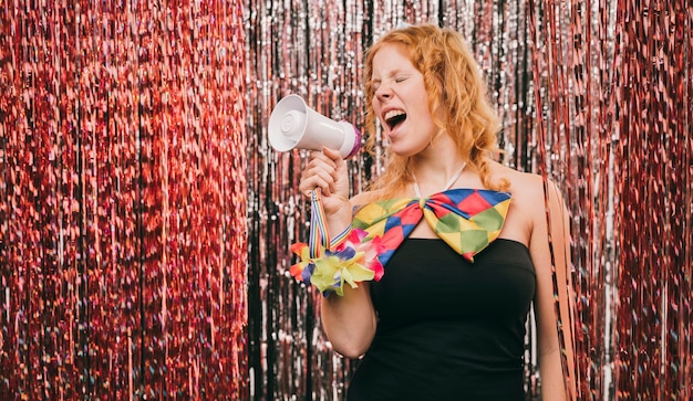 Low angle woman with megaphone at carnival party