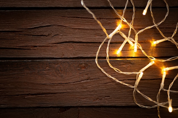 Lumières de Noël sur un vieux fond en bois texturé