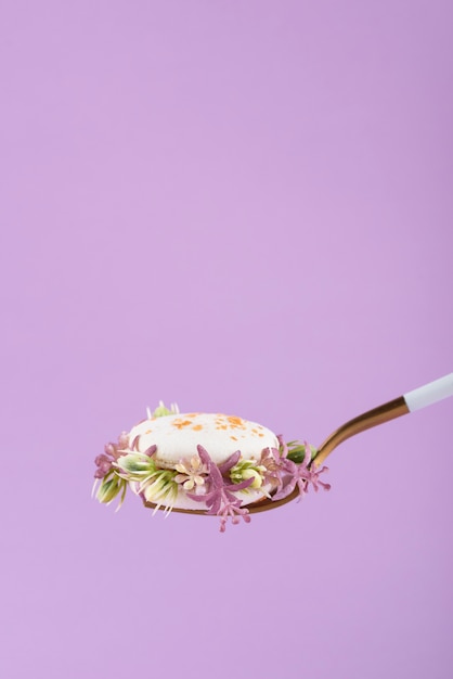 Photo gratuite macarons écologiques avec fleurs et fond violet