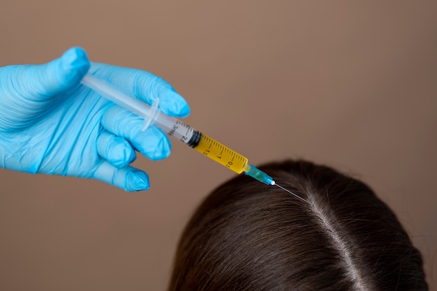 Main donnant l'injection au patient à angle élevé