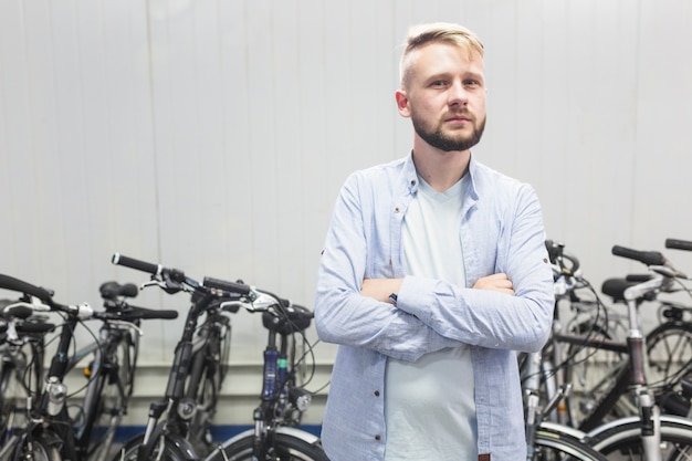 Mâle mécanicien debout devant le vélo