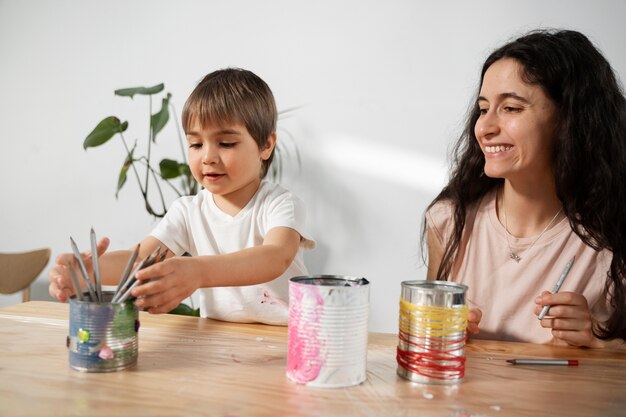 Maman montre à son enfant comment réutiliser les matériaux de manière créative