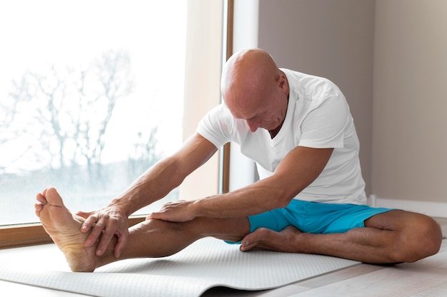 Man faisant des exercices de sport à côté de sa fenêtre