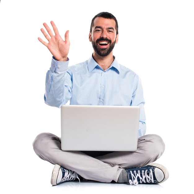 Man with laptop saluting