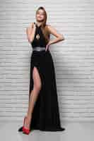 Photo gratuite mannequin attrayant posant en robe de soirée noire