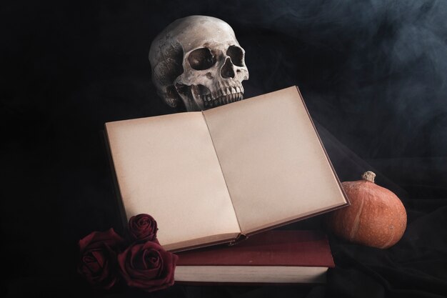 Maquette de livre ouvert avec roses et crâne