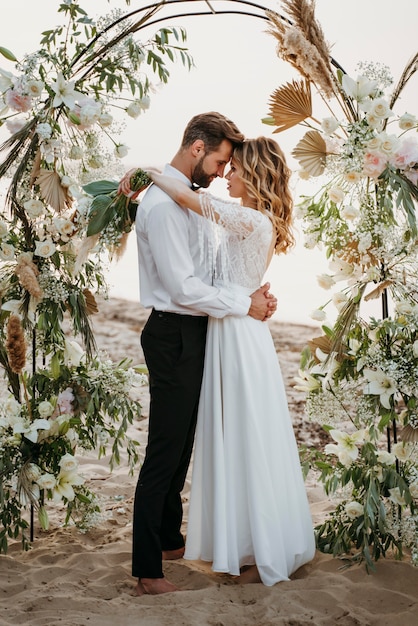 La mariée et le marié se marient sur la plage.