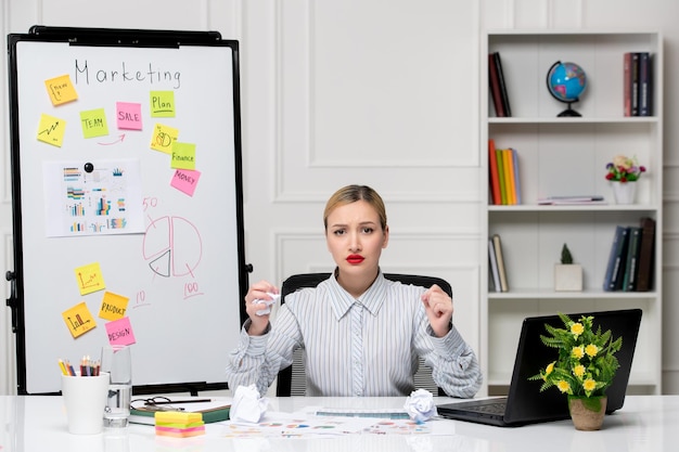 Photo gratuite marketing intelligent jolie femme d'affaires en chemise rayée au bureau en colère tenant les poings