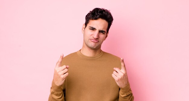 Avec une mauvaise attitude, l'air fier et agressif, pointant vers le haut ou faisant un signe amusant avec les mains