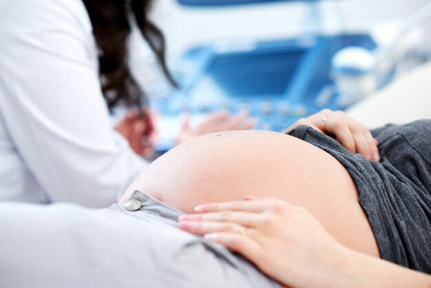 Médecin effectuant une échographie pour sa patiente enceinte