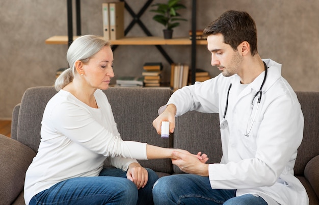 Photo gratuite médecin de tir moyen à l'aide d'un thermomètre