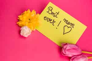 Photo gratuite meilleure maman jamais titre sur papier avec des fleurs près de