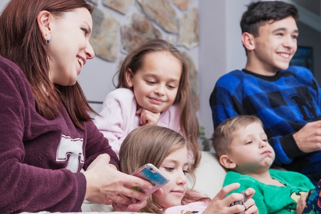 Mère et enfants utilisant des technologies