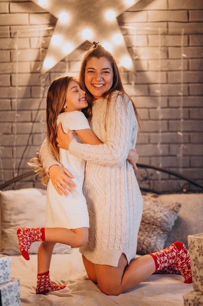 Mère avec fille au lit à Noël