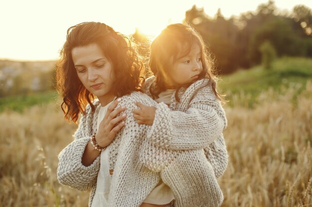 Mère avec fille jouant dans un champ d'été