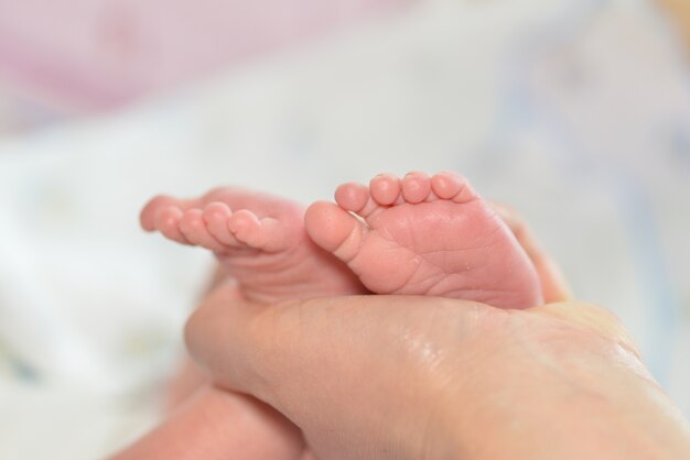 Mère massant le pied de son enfant, concentration superficielle