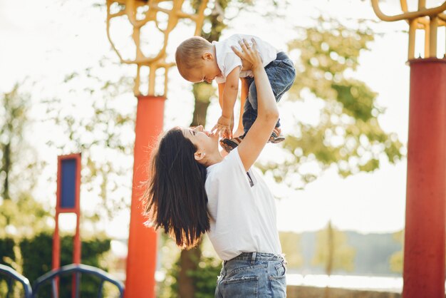 Mère avec petit enfant sur une aire de jeux