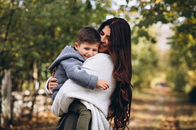 Mère avec petit fils dans un parc en automne