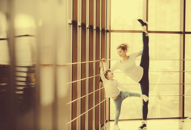 Mère à pratiquer le yoga avec sa fille