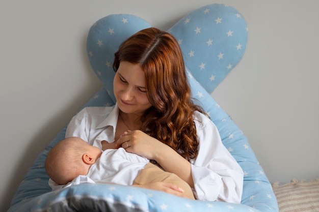 Photo gratuite mère vue de face avec bébé à la maison