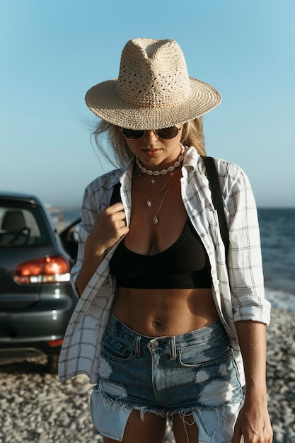 Mid shot femme blonde avec chapeau en mer