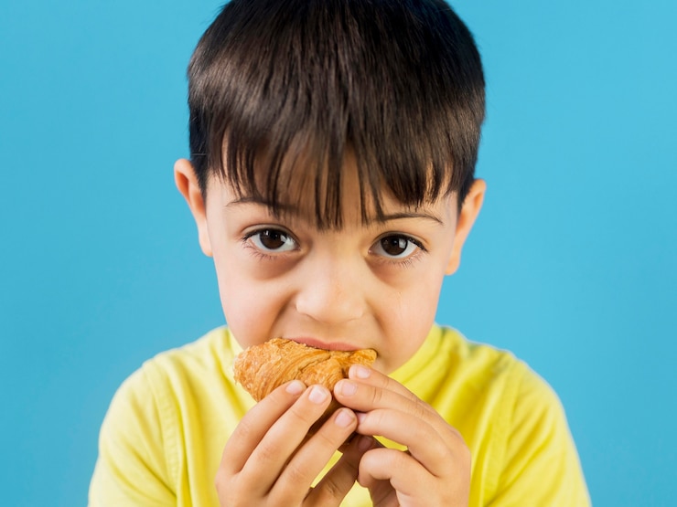Photo gratuit mignon, enfant, manger, croissant