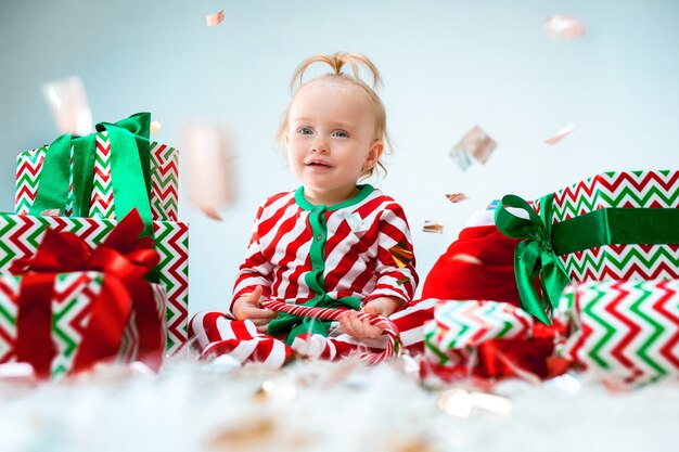 Mignonne petite fille de 1 an près du bonnet de Noel posant pour Noël