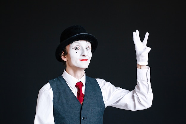 Mime montre un signe de victoire avec ses doigts