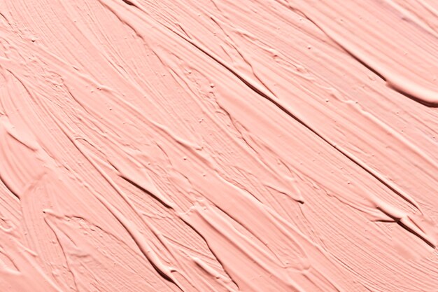 Mise à plat de coups de pinceau de peinture rose sur la surface