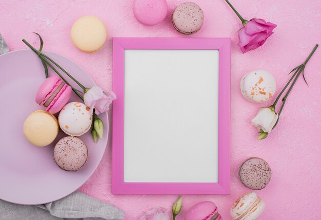 Mise à plat du cadre avec des roses et des macarons