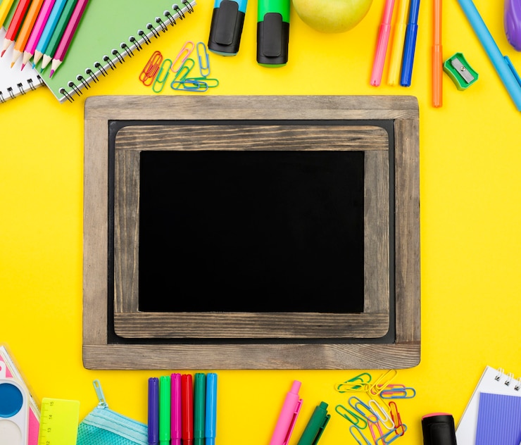 Photo gratuit mise à plat des éléments essentiels de l'école avec des crayons et un tableau noir