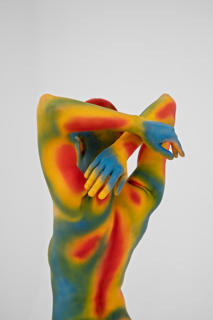 Photo gratuit modèle homme posant avec body painting coloré