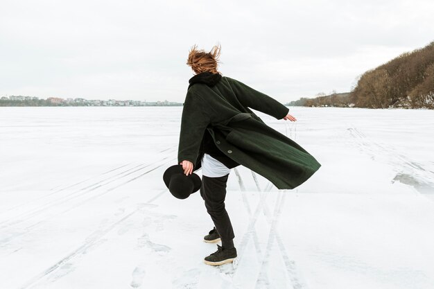 Modèle masculin posant dans des vêtements d'hiver à la lumière du jour