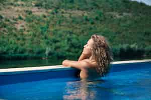 Photo gratuite modèle relaxant dans la piscine sur la nature