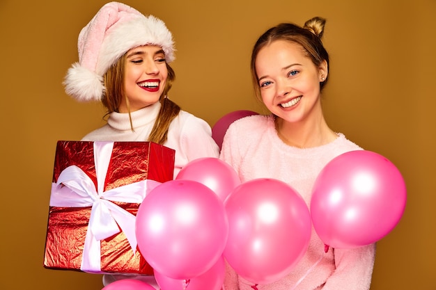 Modèles avec grand coffret cadeau et ballons roses à Noël