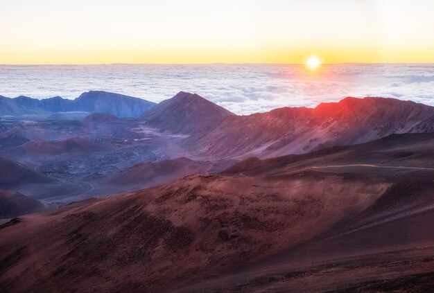 Montagnes brunes et blanches sous des nuages blancs