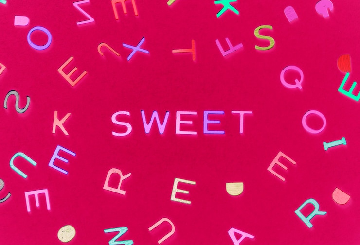 Photo gratuit mot d'épeautre doux avec fond d'alphabets