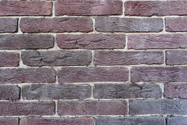 Mur de briques brunes. Texture de vieille brique brun foncé et rouge avec remplissage blanc